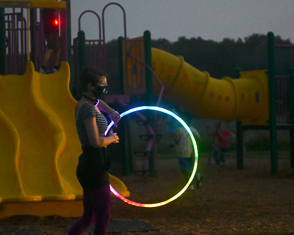 Rose Neal performs with her hula hoop while she is outside Saturday at Twin Lakes Park in Columbia.